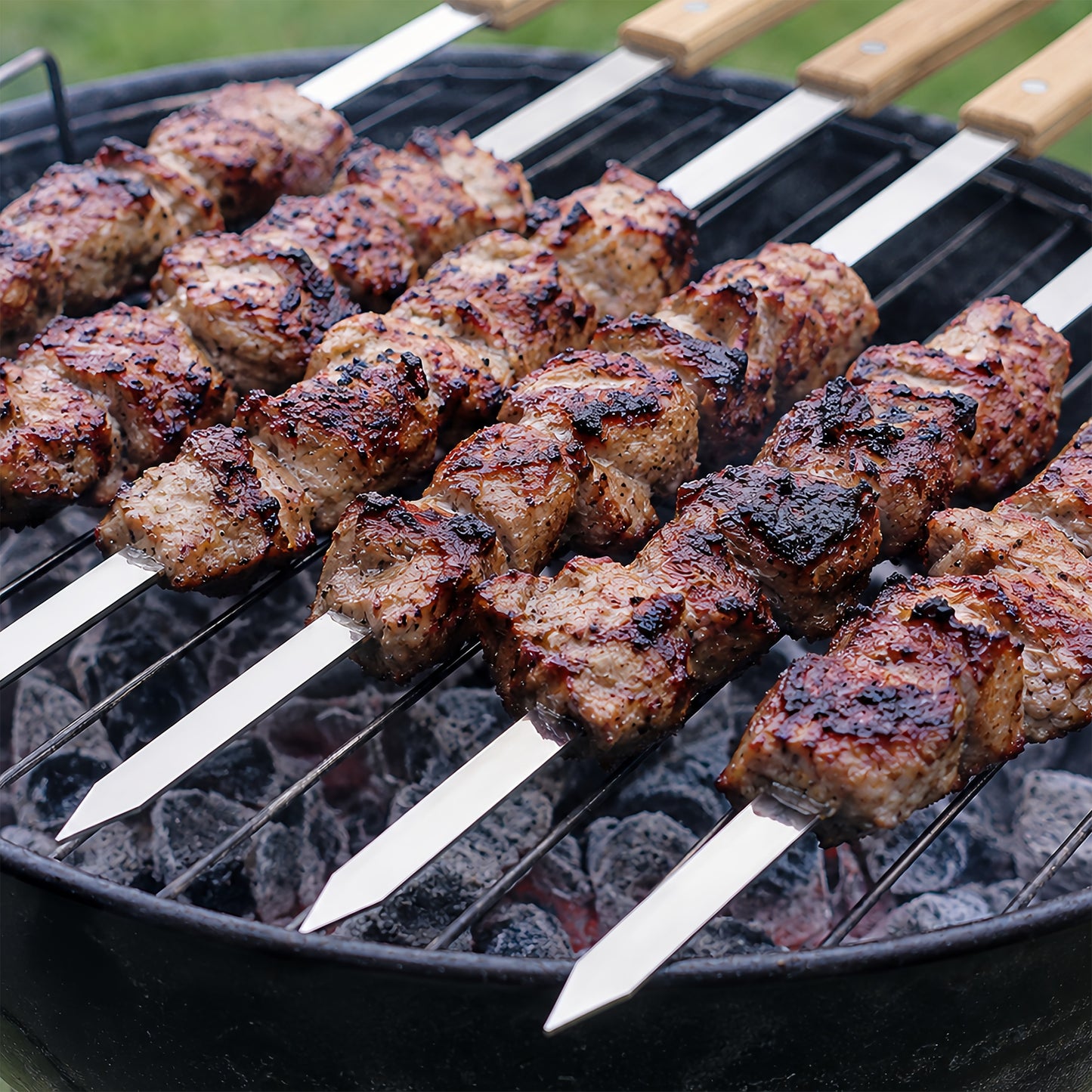Flat stainless steel kebab skewer with 1 cm wide blade to help prevent food from spinning while grilling