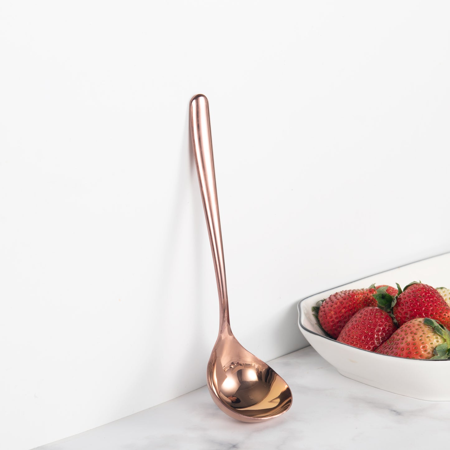 IMEEA Rose Gold Sauce Ladle displayed upright with a warm metallic tone and graceful long handle