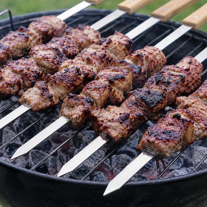 Flat stainless steel kebab skewer with 1 cm wide blade to help prevent food from spinning while grilling