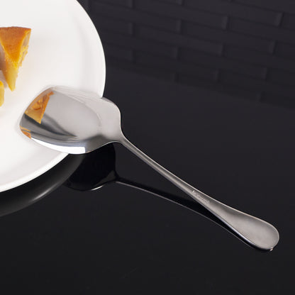 Stainless Steel Serving Spoon showcasing its smooth ergonomic design while resting on the edge of a plate