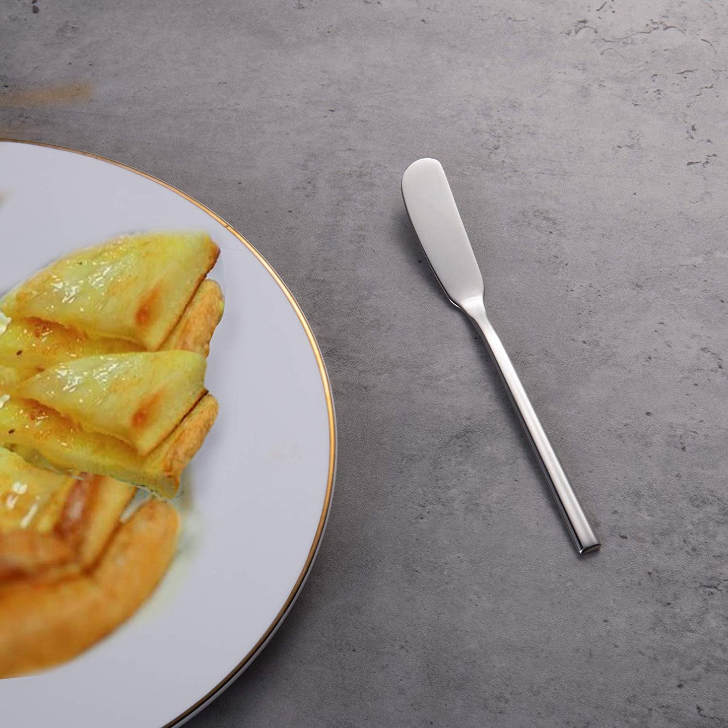 Elegant Stainless Steel Butter Knife with sleek design beside a dining plate