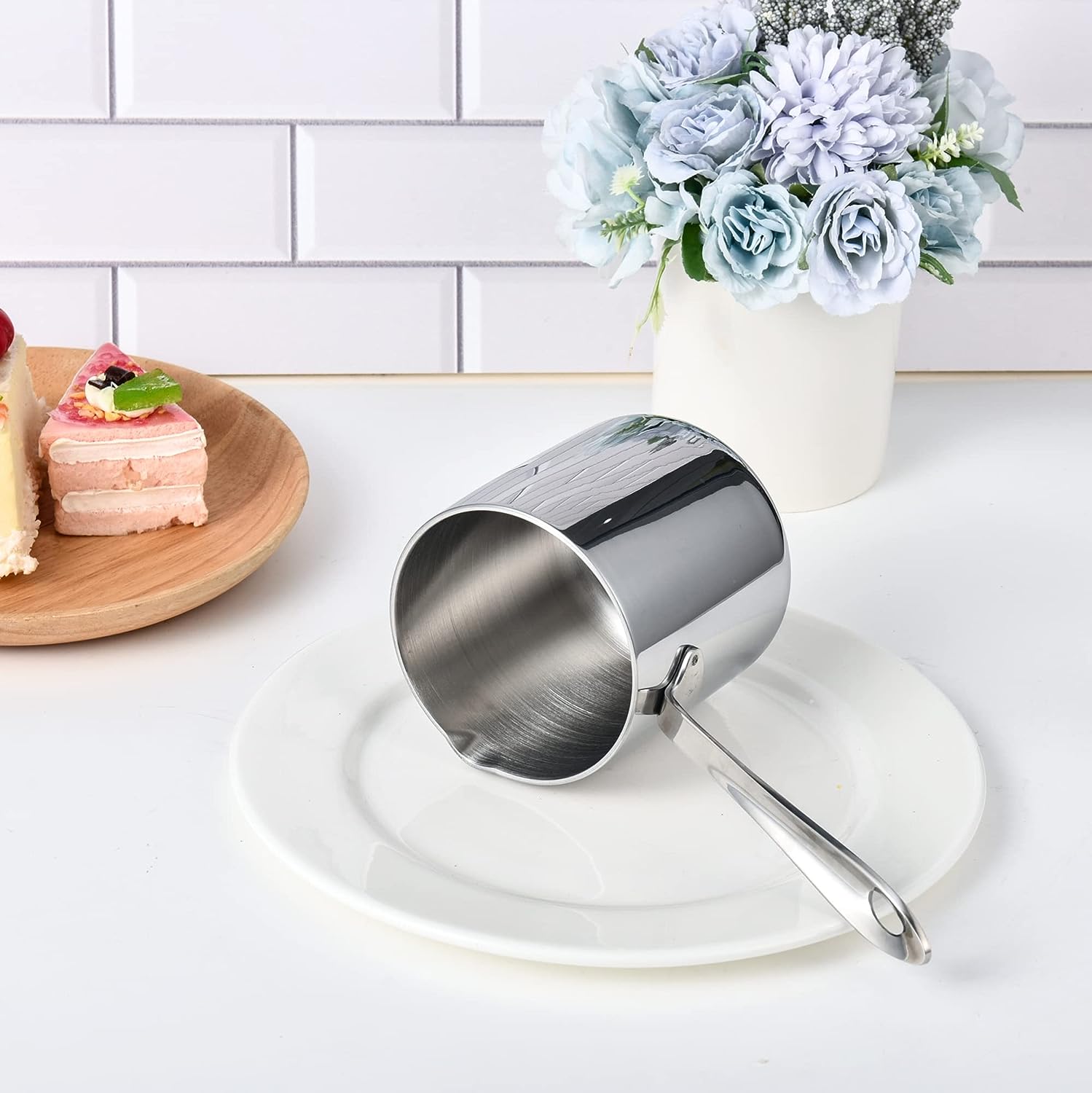 Stainless Steel Small Saucepan with Spout displayed on a plate for a clean table arrangement