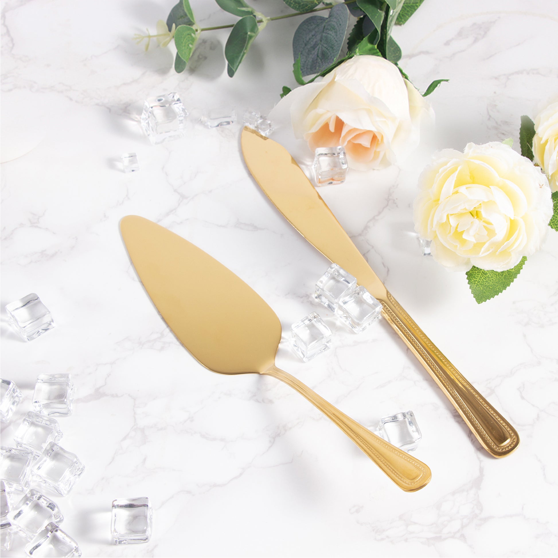 IMEEA gold cake knife and server set displayed on a table, showcasing its elegant gold finish and two-piece design