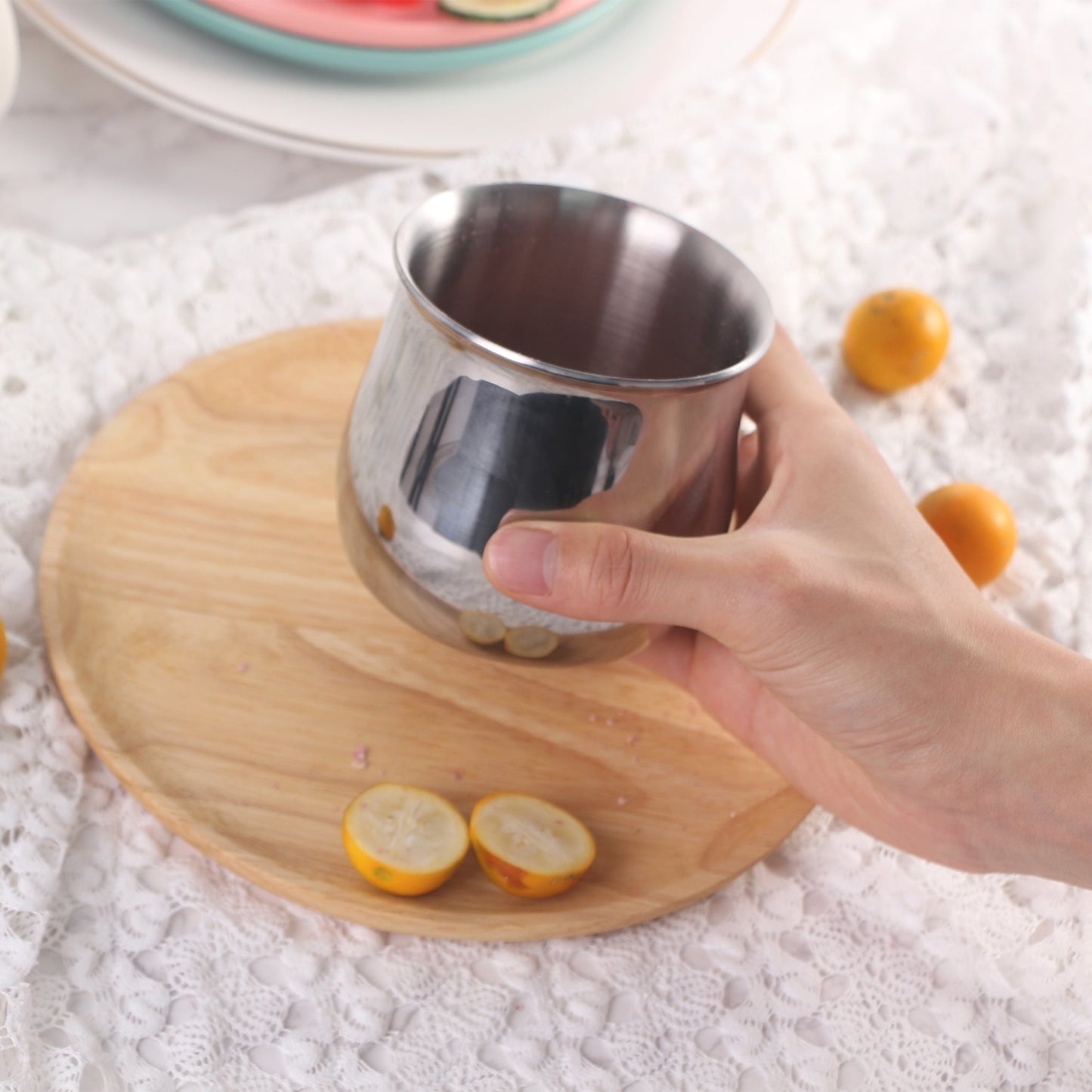Multi Function Cereal Cup held by hand on a wooden tray
