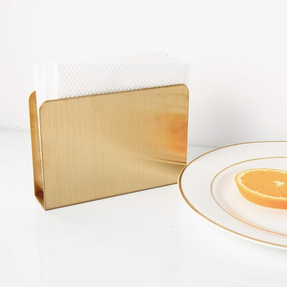 英文 Alt：
Elegant IMEEA gold stainless steel cocktail napkin holder displayed beside a dining plate with a reflective finish