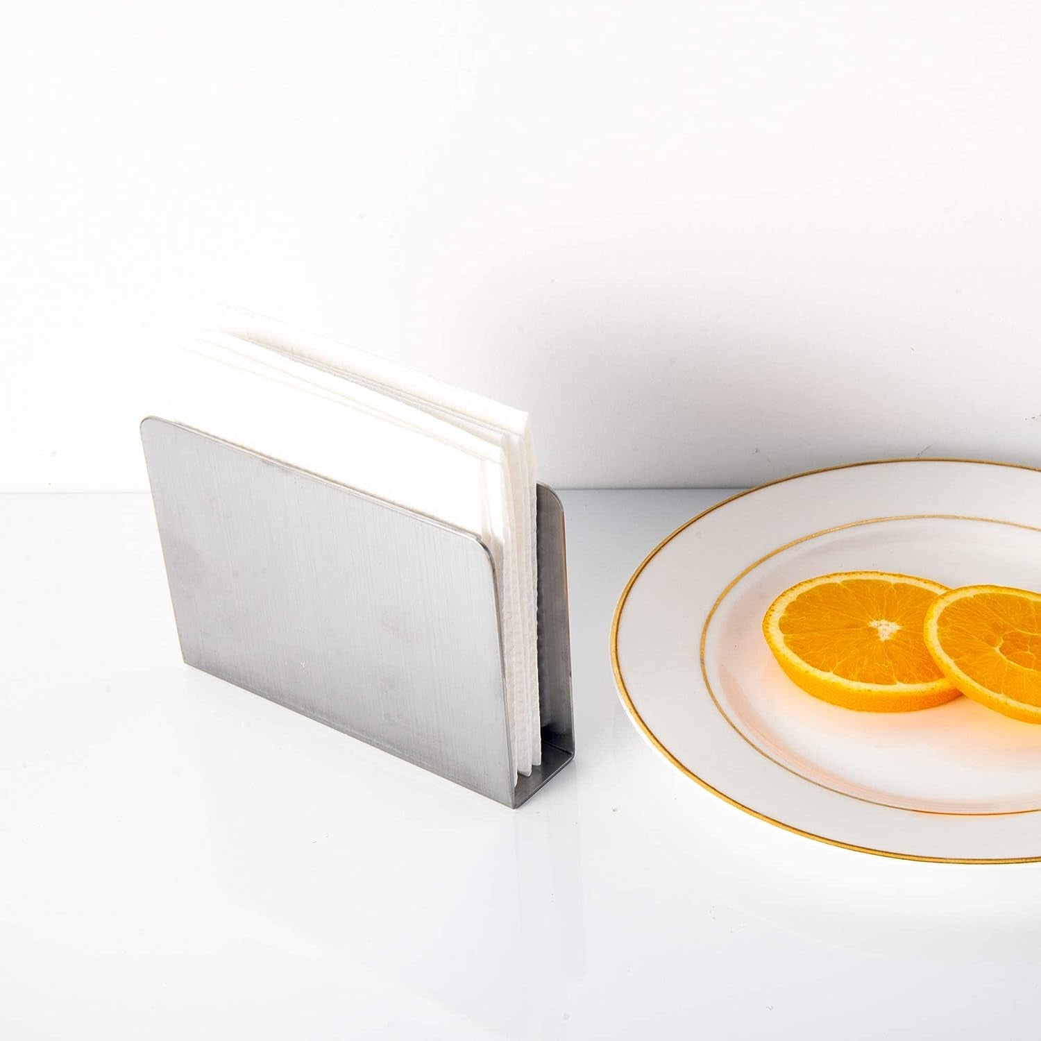 Stainless Steel Cocktail Napkin Holder with napkins beside oranges