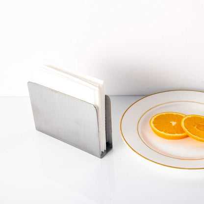 Stainless Steel Cocktail Napkin Holder with napkins beside oranges
