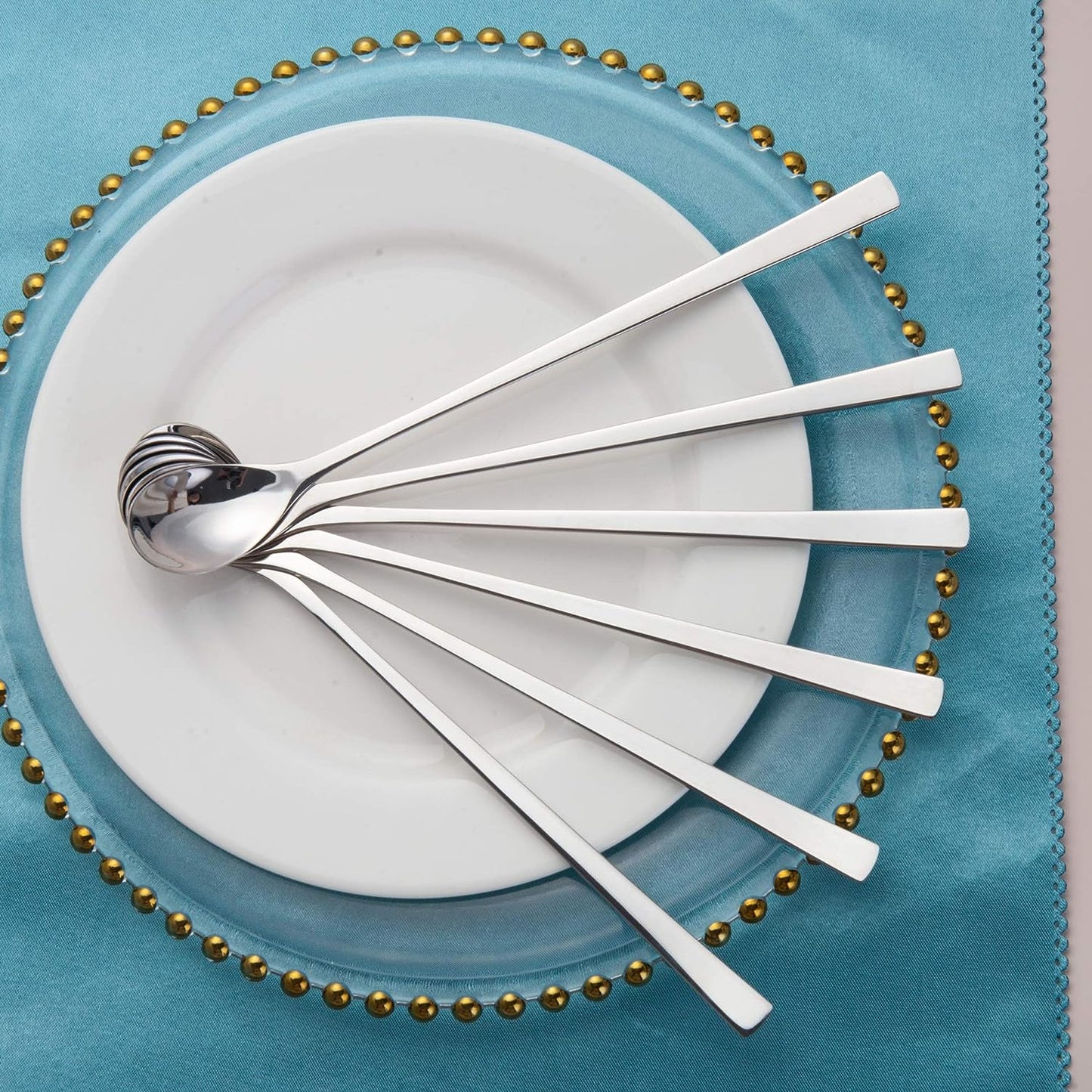 18/10 Stainless Steel Long Handled Spoon Set arranged in a fan shape on a plate, showcasing an elegant design for table settings