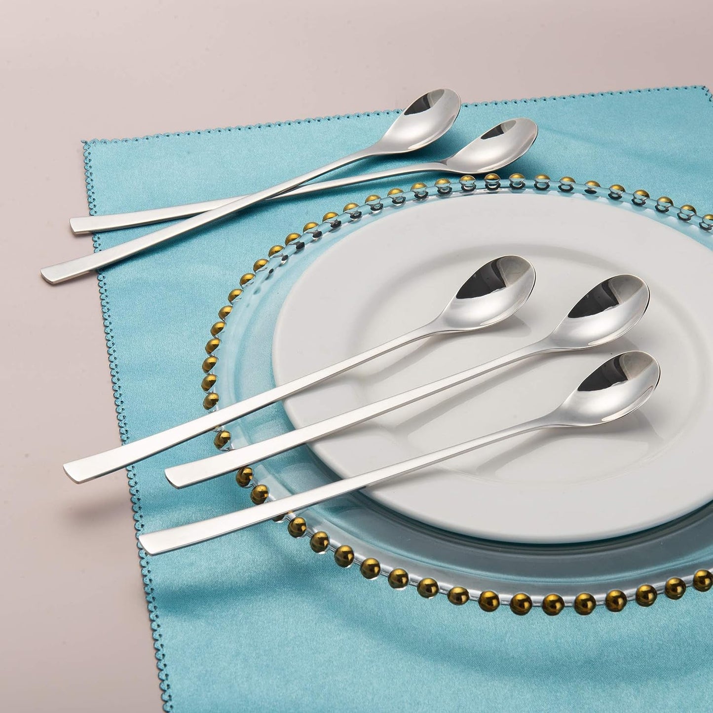 Iced Tea Spoons arranged on a plate with a blue placemat, highlighting the ergonomic long handle design