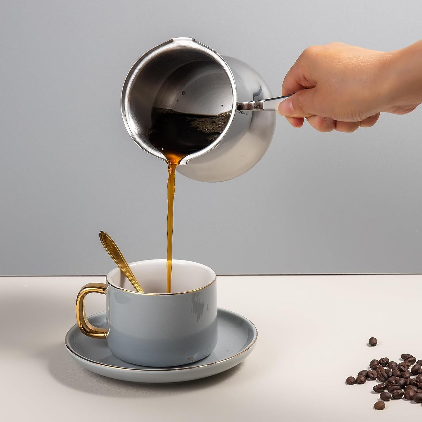 IMEEA 18/10 Stainless Steel Turkish Coffee Pot pouring coffee into a cup