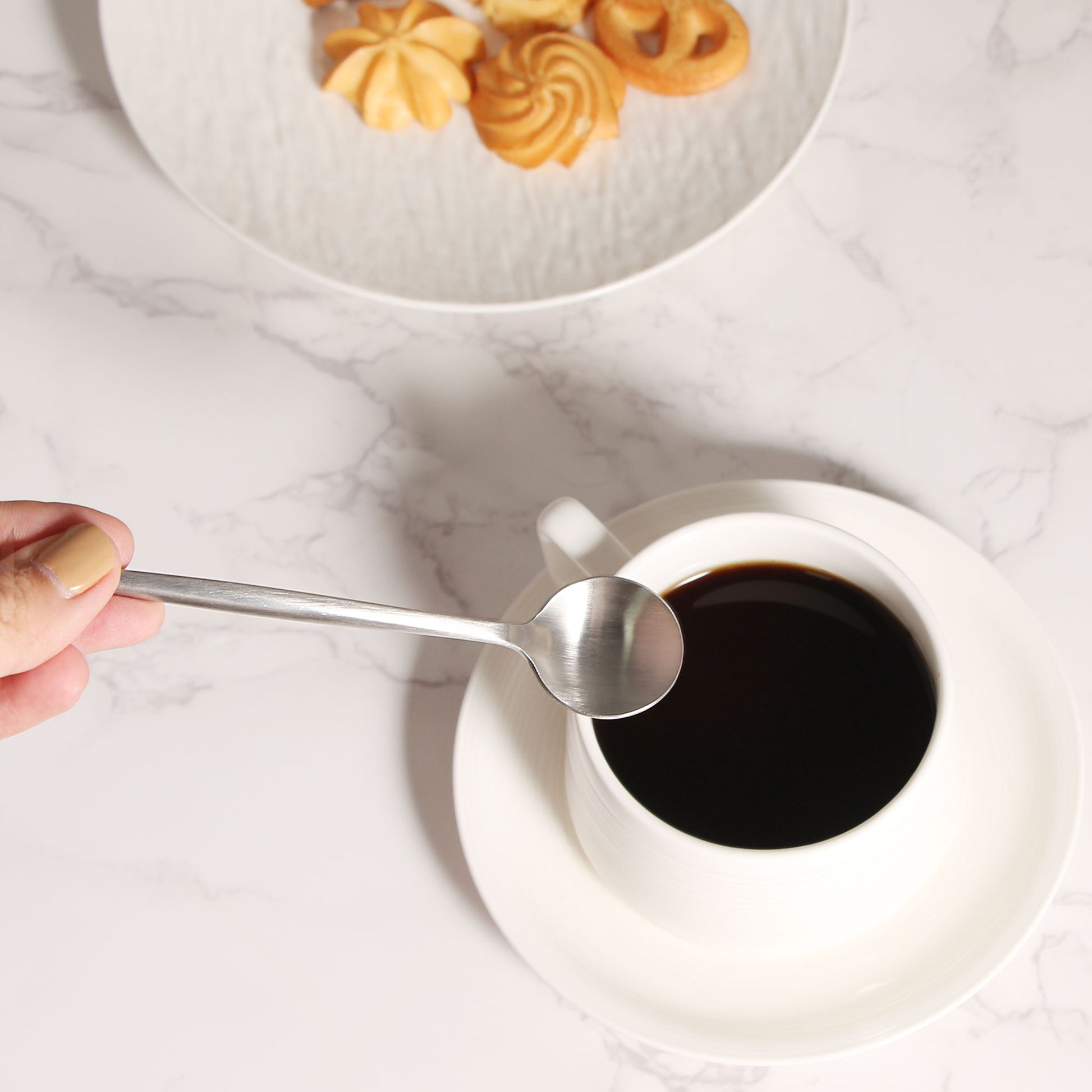 IMEEA Stainless Steel Coffee Spoons held over a coffee cup