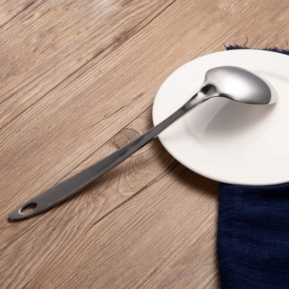IMEEA stainless steel serving spoons displayed on a plate with a polished finish