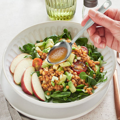 Stainless steel serving spoon set in use during a meal