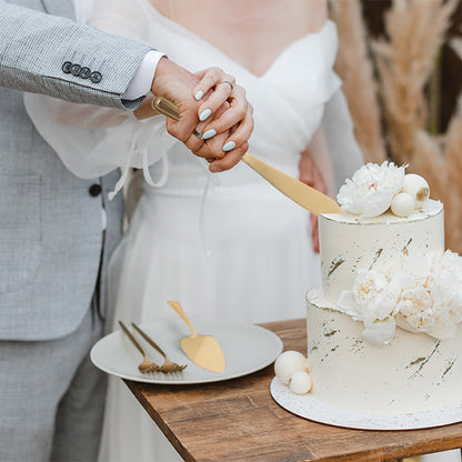 IMEEA gold cake knife cutting into a cake, showcasing its sleek design and smooth slicing performance