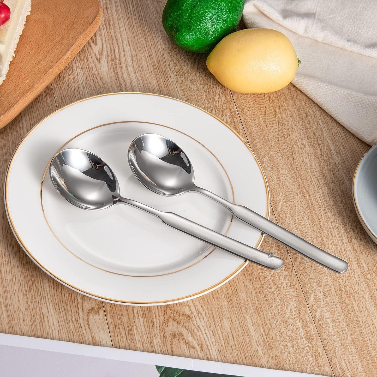 Elegant IMEEA 316 Stainless Steel Round Bowl Dinner Spoons placed on a dining plate