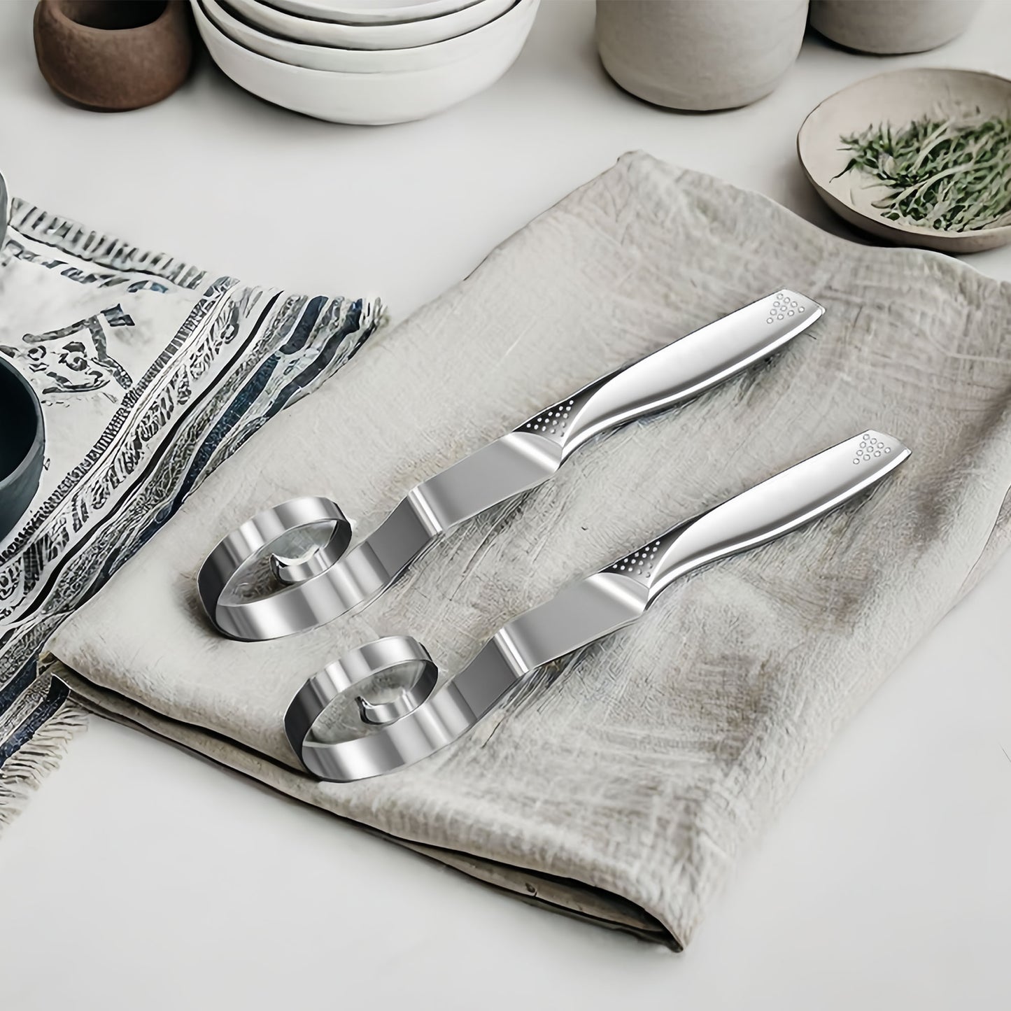 Stainless steel dough whisk on fabric, highlighting its structure and design