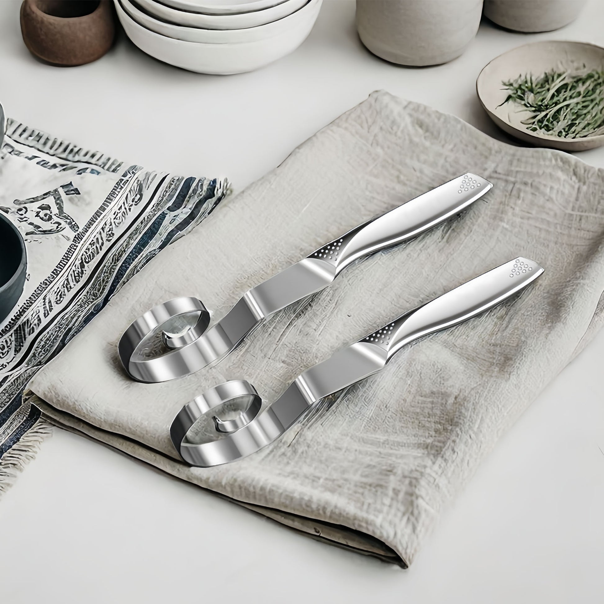 Stainless steel dough whisk on fabric, highlighting its structure and design