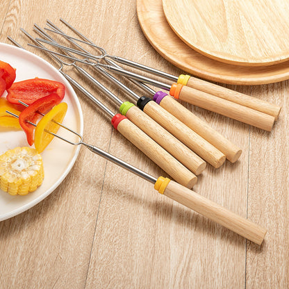 Extendable Stainless Steel Marshmallow Roasting Sticks arranged on a wooden table from a top view