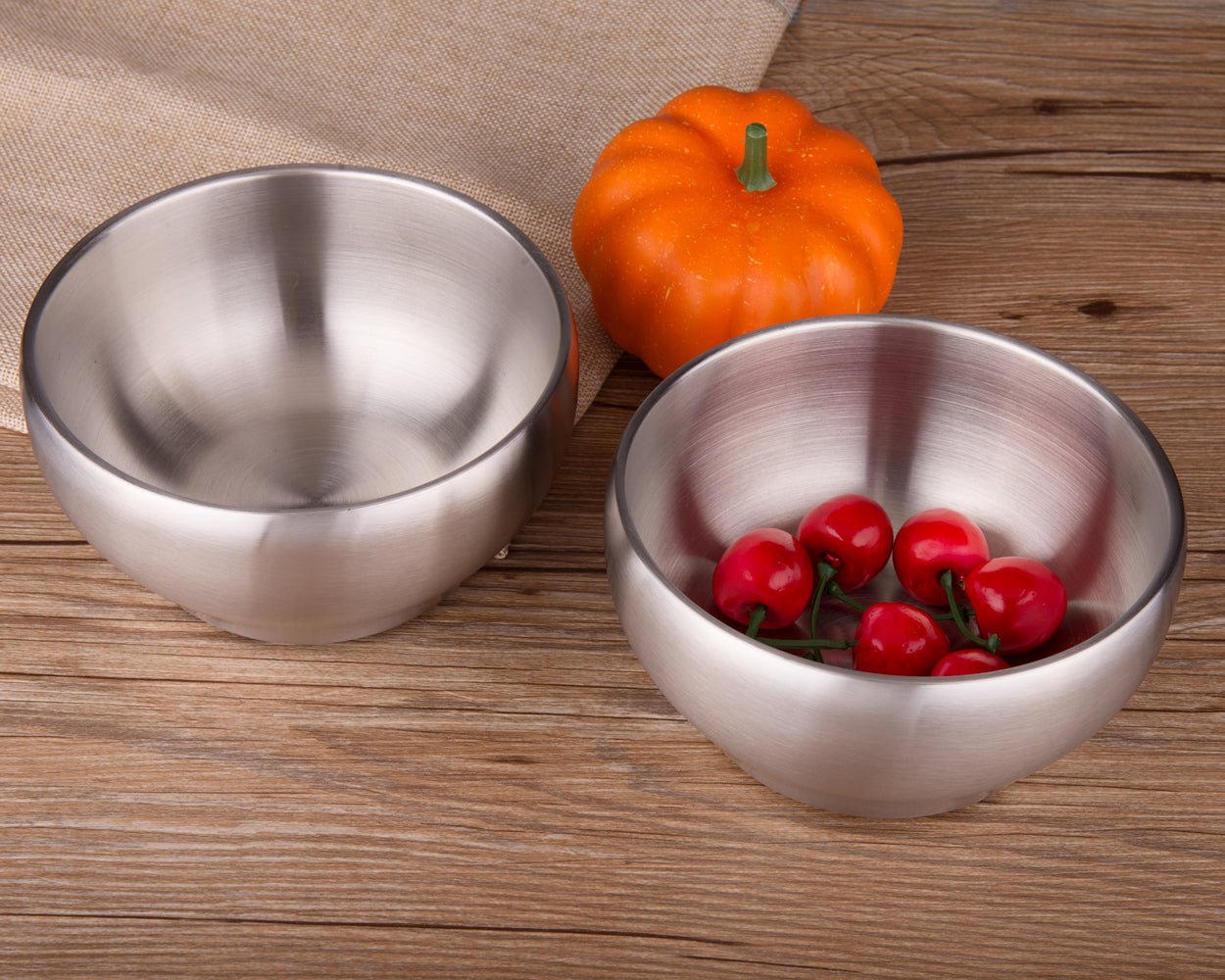 IMEEA double wall stainless steel bowl filled with cherries on a dining table, featuring an easy-to-clean surface for everyday use