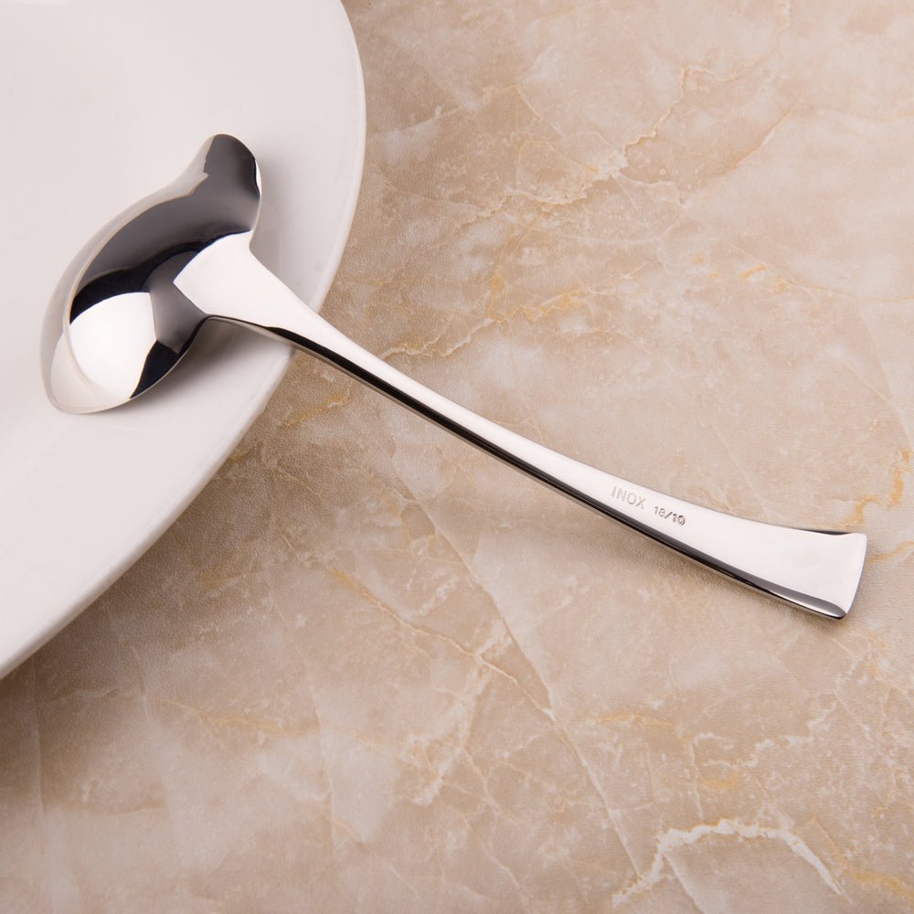 Mini Stainless Steel Gravy Ladle placed on a bowl edge for serving sauces and small portions