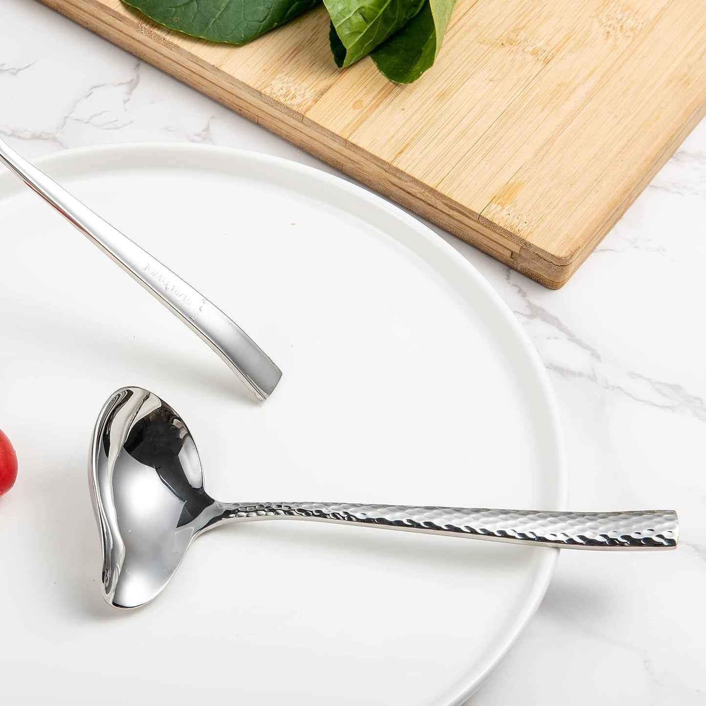 18/10 Stainless steel gravy ladle placed on a clean plate, showcasing the elegant design and polished surface
