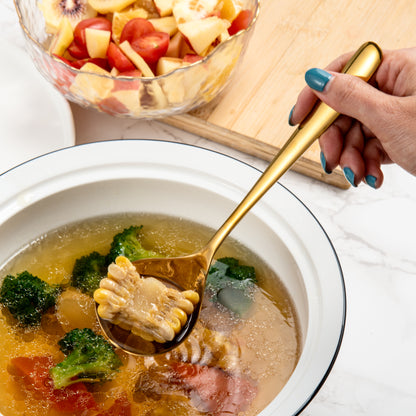 IMEEA Gold Stainless Steel Sauce Ladle serving soup with corn in a dining setting
