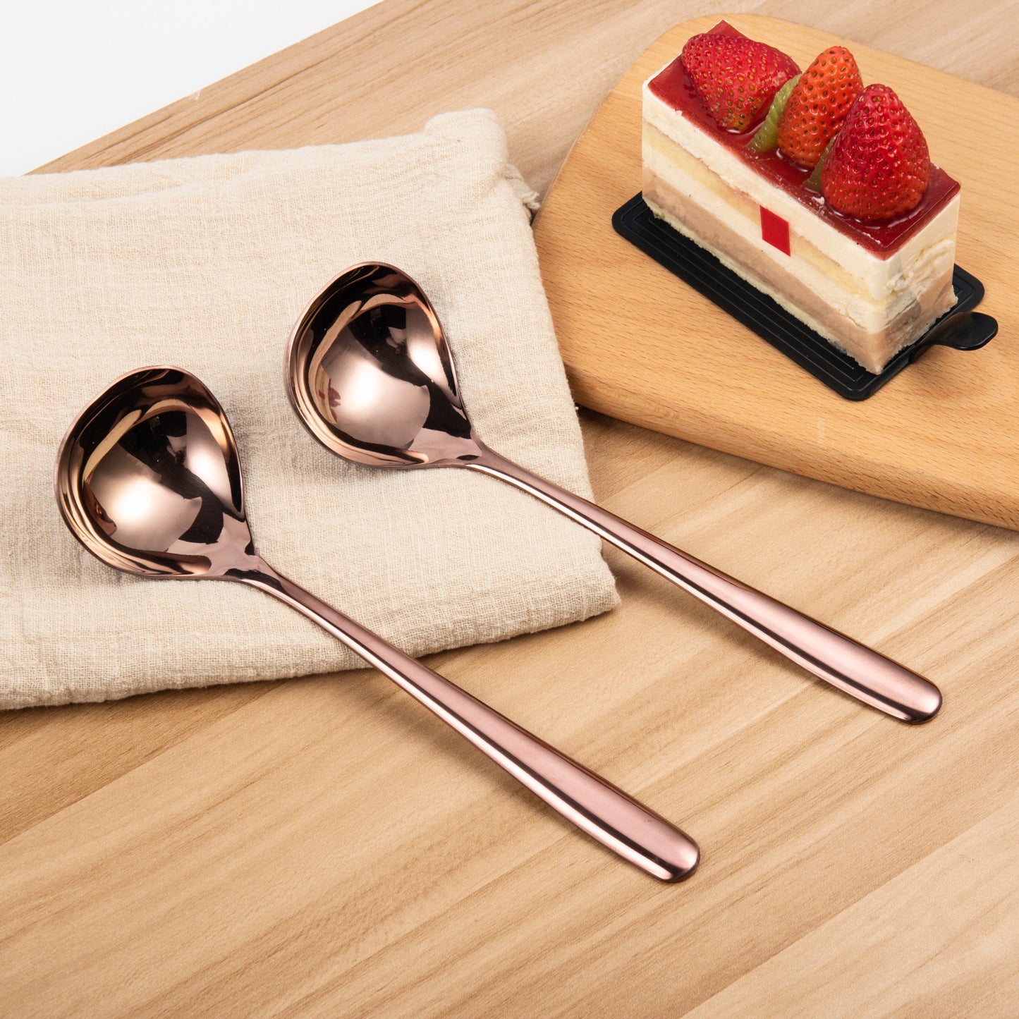 IMEEA Rose Gold Sauce Ladles placed on a table showcasing the warm metallic finish and coordinated pair design
