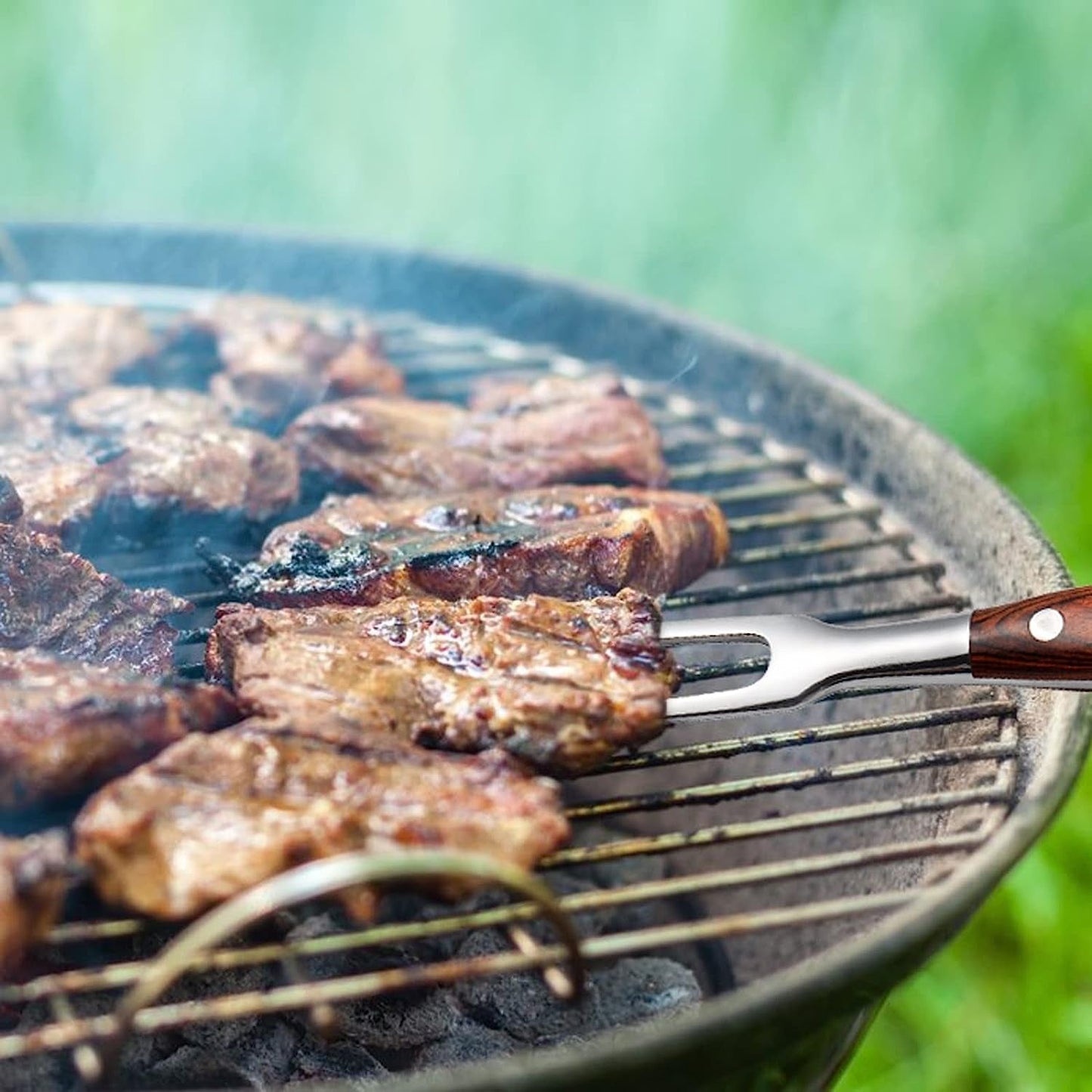 Durable Stainless steel carving fork holding grilled meat on a barbecue grill