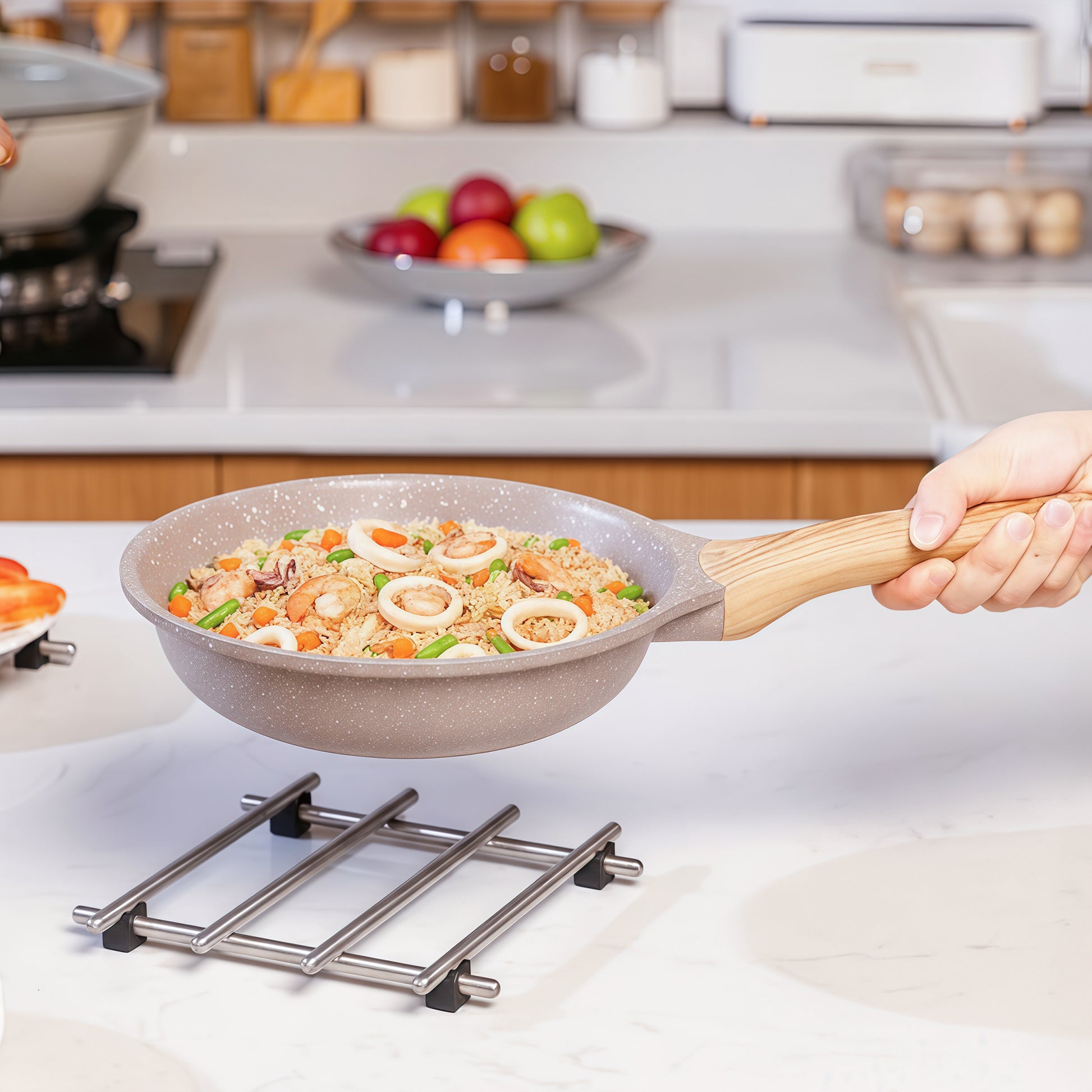 IMEEA trivet supporting a frying pan, preventing burns and scratches on wood, granite, or glass surfaces