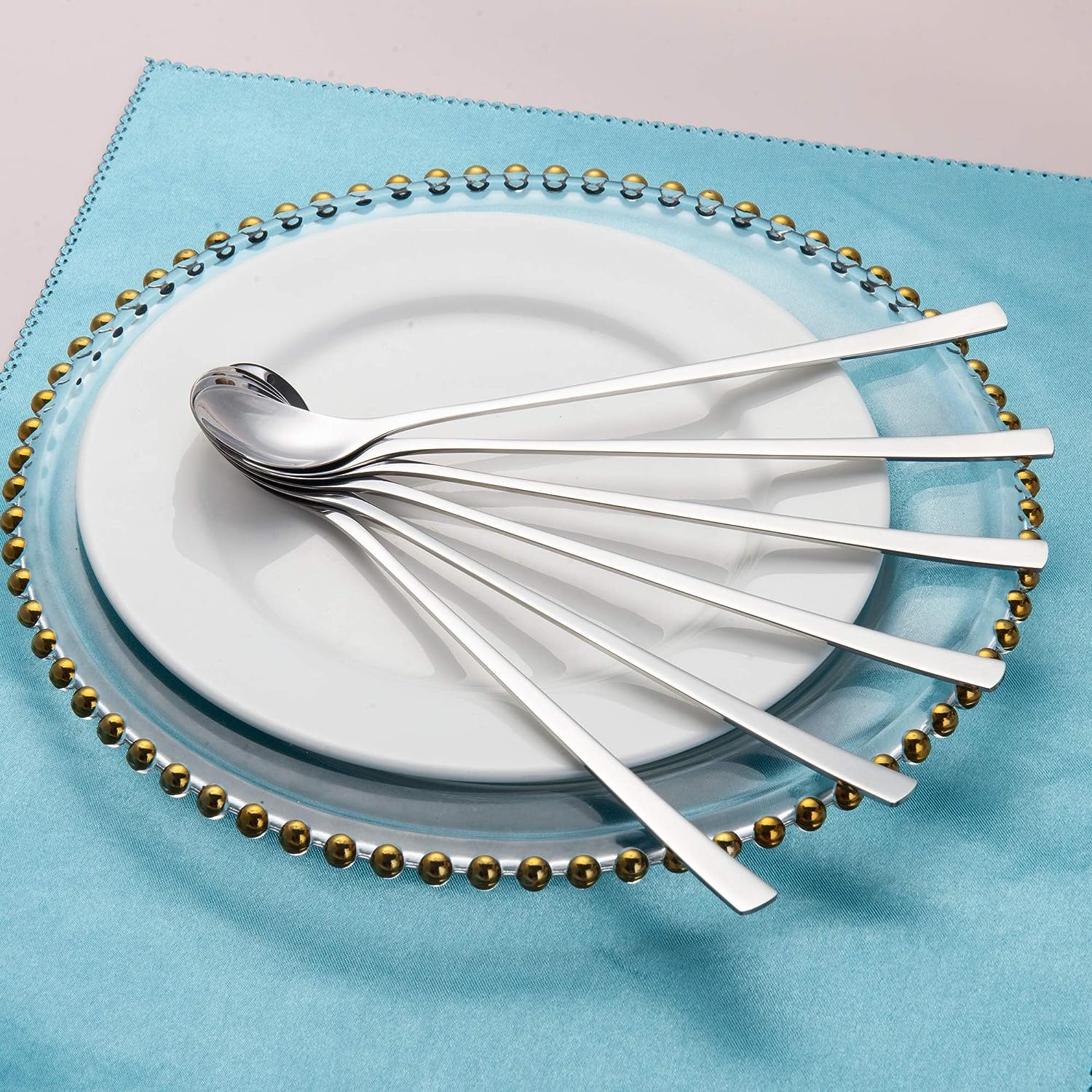 IMEEA Long Handled Spoon Set arranged in a fan shape on a plate, showcasing an elegant design for table settings