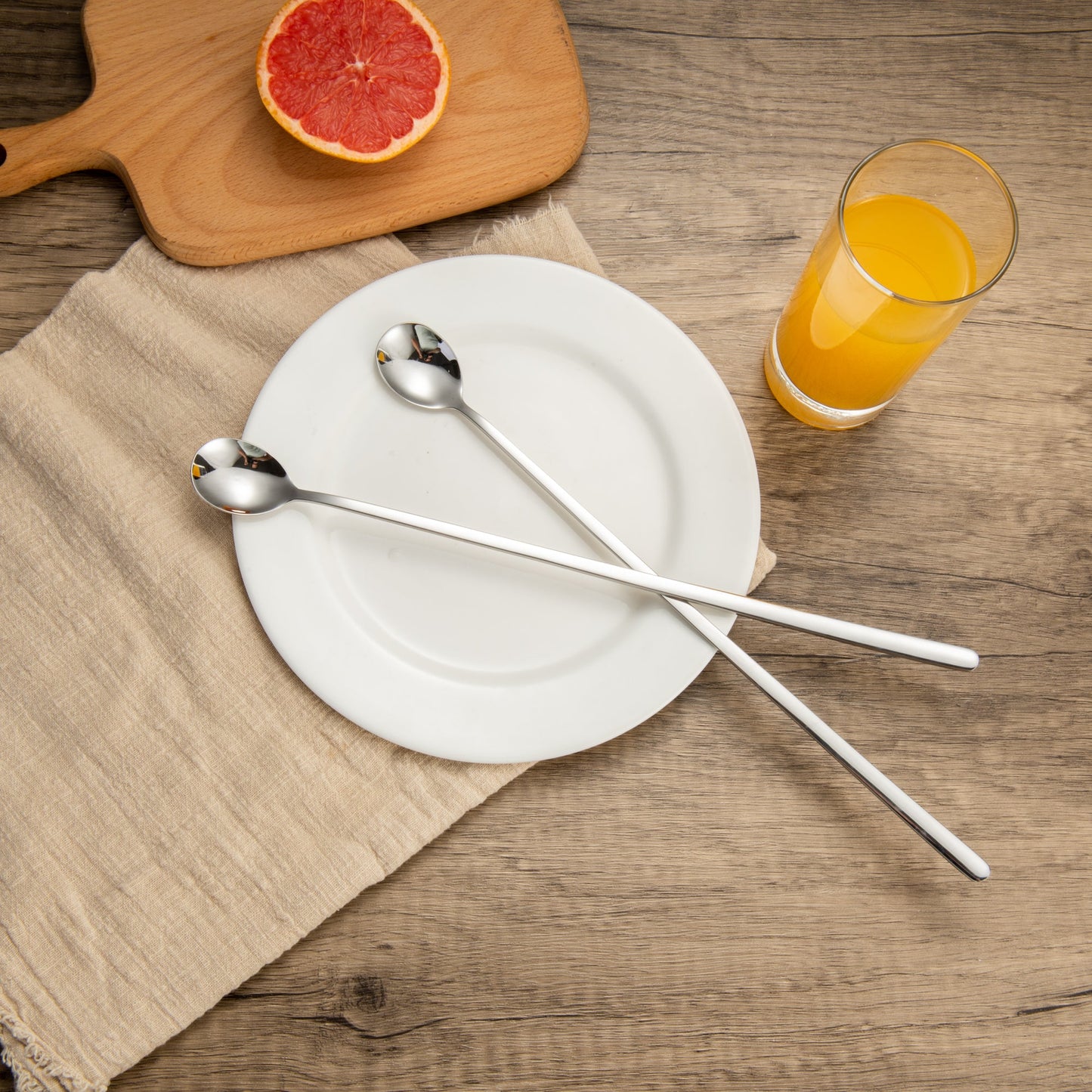 IMEEA Long Handle Spoon placed on a plate for elegant table setting and serving