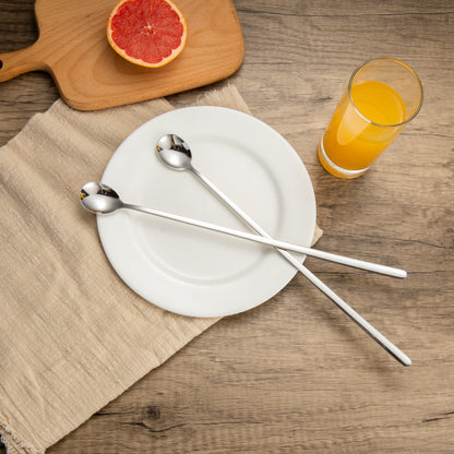 IMEEA Long Handle Spoon placed on a plate for elegant table setting and serving