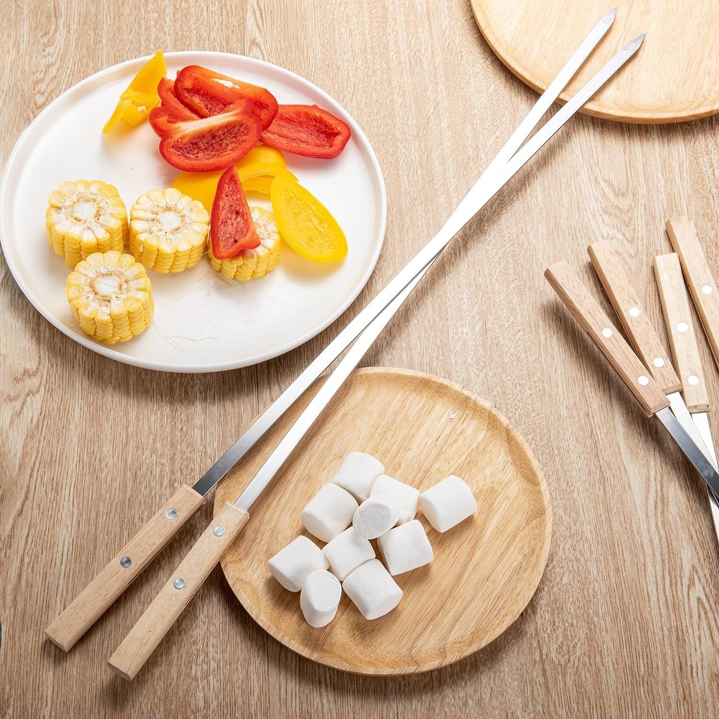 IMEEA stainless steel kabob skewers on a table with barbecue ingredients