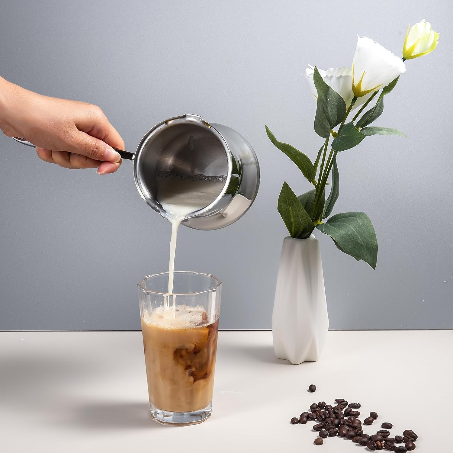 IMEEA 18/10 Stainless Steel Milk Frothing Pitcher pouring milk into a coffee cup