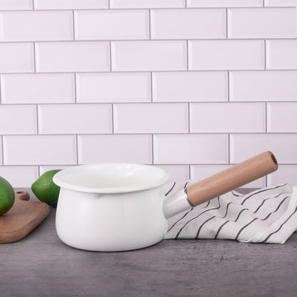 enamel saucepan front view displayed on a table, showcasing its clean design and smooth enamel finish for everyday kitchen use