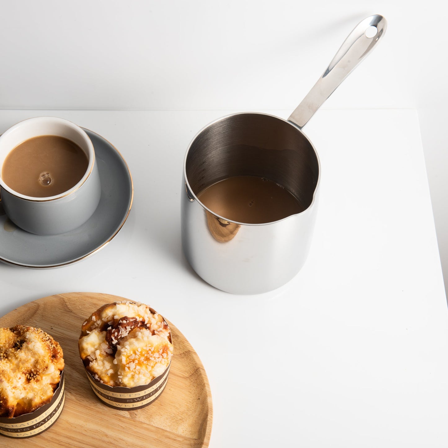Elegant Stainless Steel Butter Warmer serving coffee in a dessert setting with a smooth polished surface