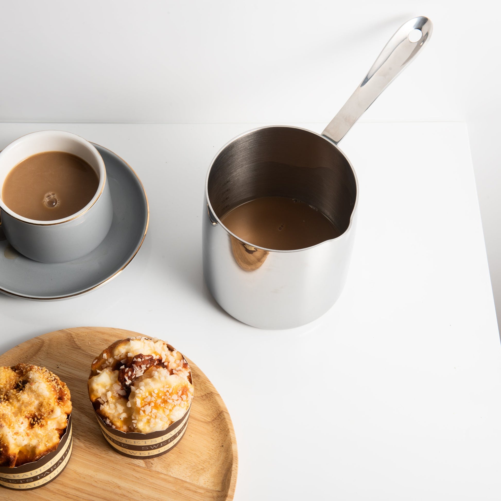 Elegant Stainless Steel Butter Warmer serving coffee in a dessert setting with a smooth polished surface
