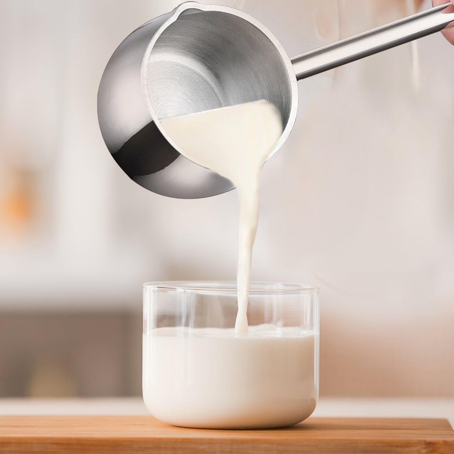 IMEEA Mini Saucepan pouring warm milk into a cup for daily beverage preparation