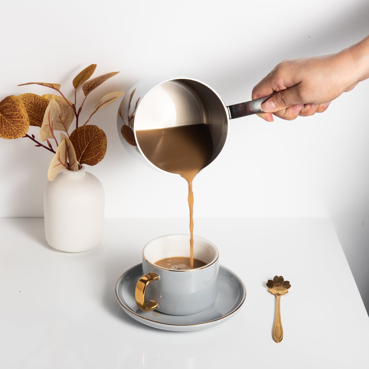 Comfortable Handle 18/10 Stainless Steel Saucepan pouring coffee into a cup