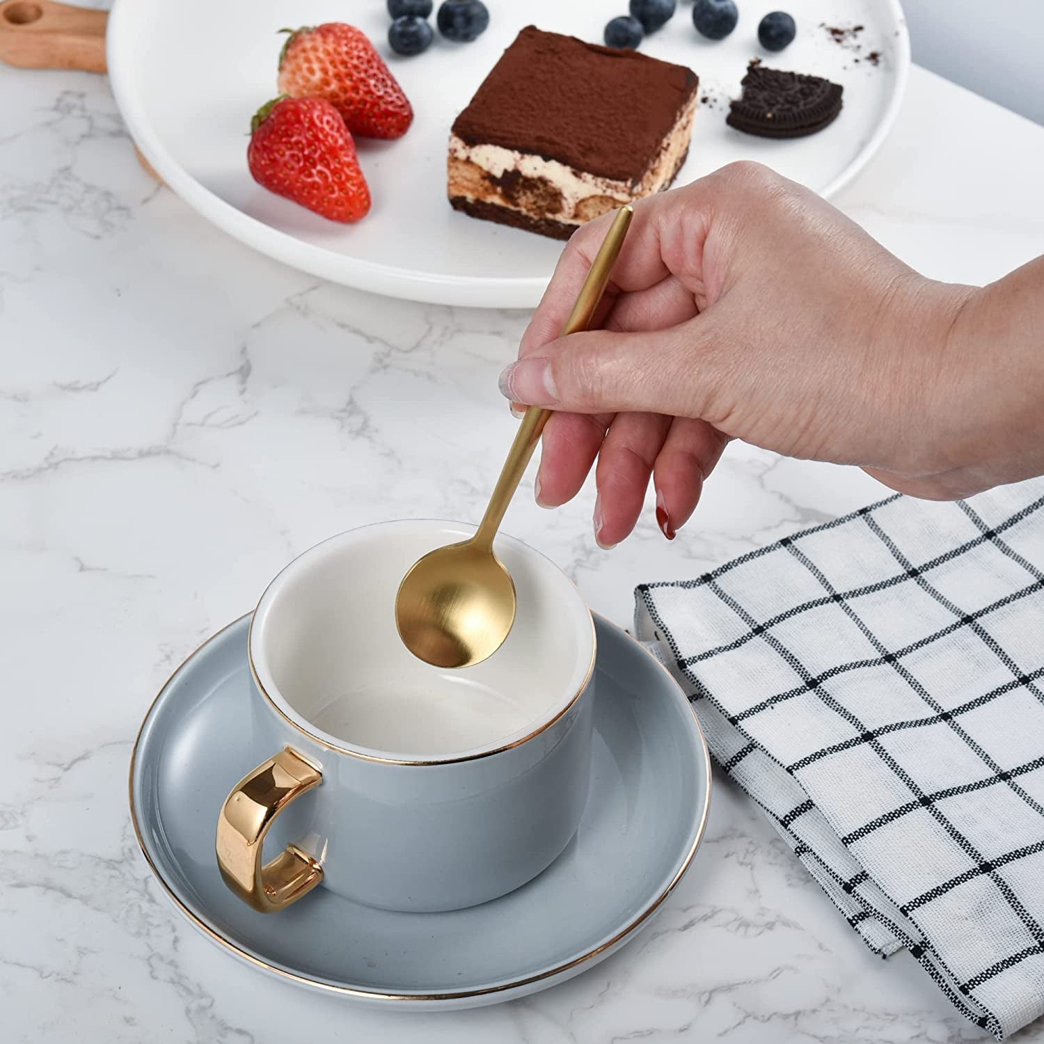 IMEEA Coffee Spoons SUS304 Stainless Steel with matte gold finish held in hand from a tea cup