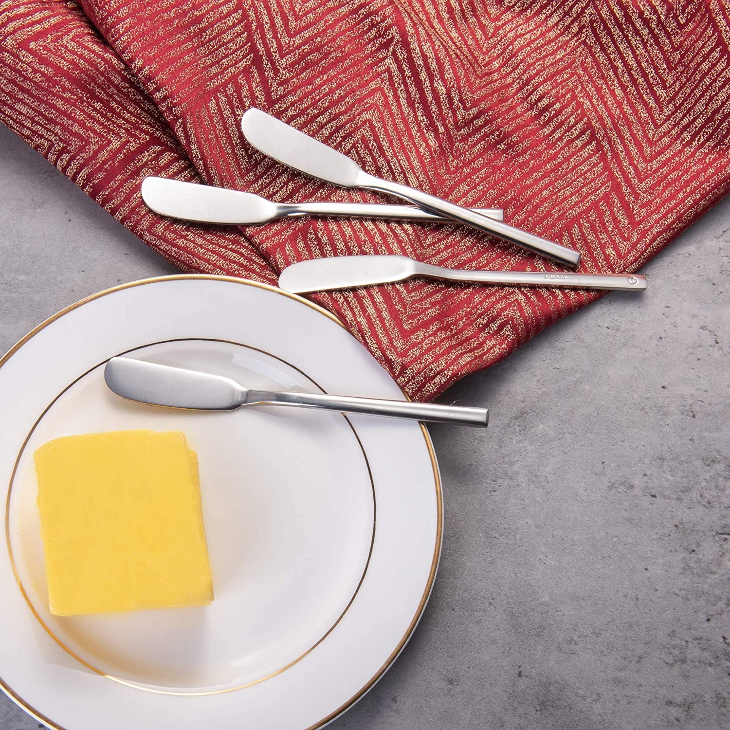 Multi-Use Stainless Steel Butter Knife for spreading butter, displayed with a butter plate