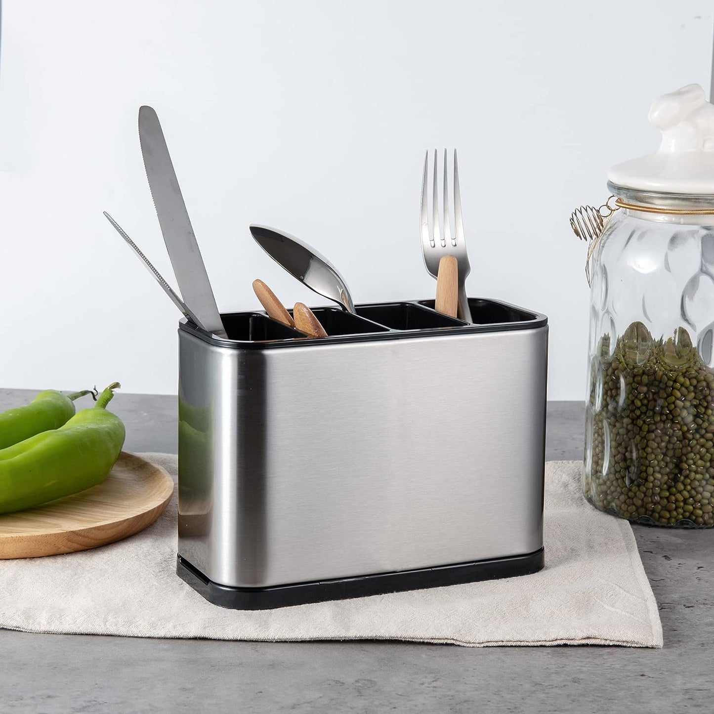 Multi Compartment Flatware Holder featuring organized sections for separating silverware and kitchen tools on the table