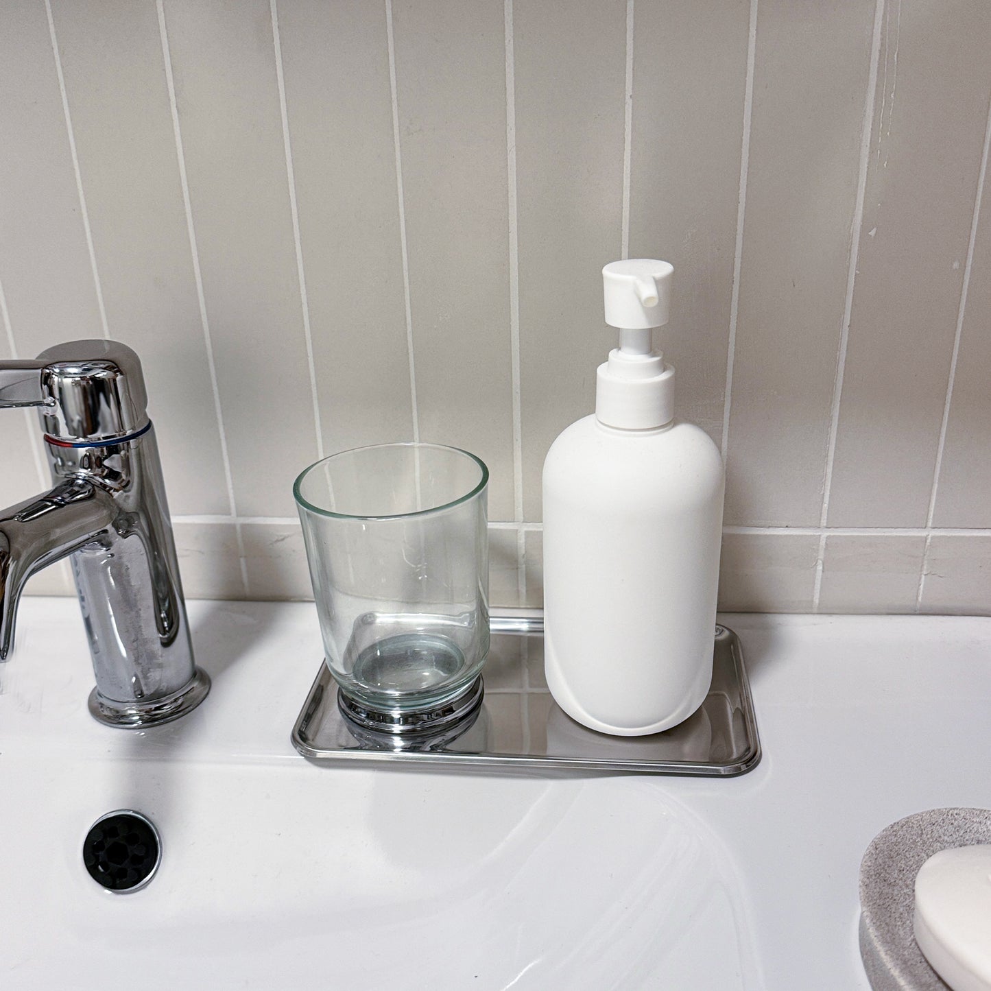 Mirror Polished Stainless Steel Tray organizing soap bottles and bathroom accessories on a vanity counter