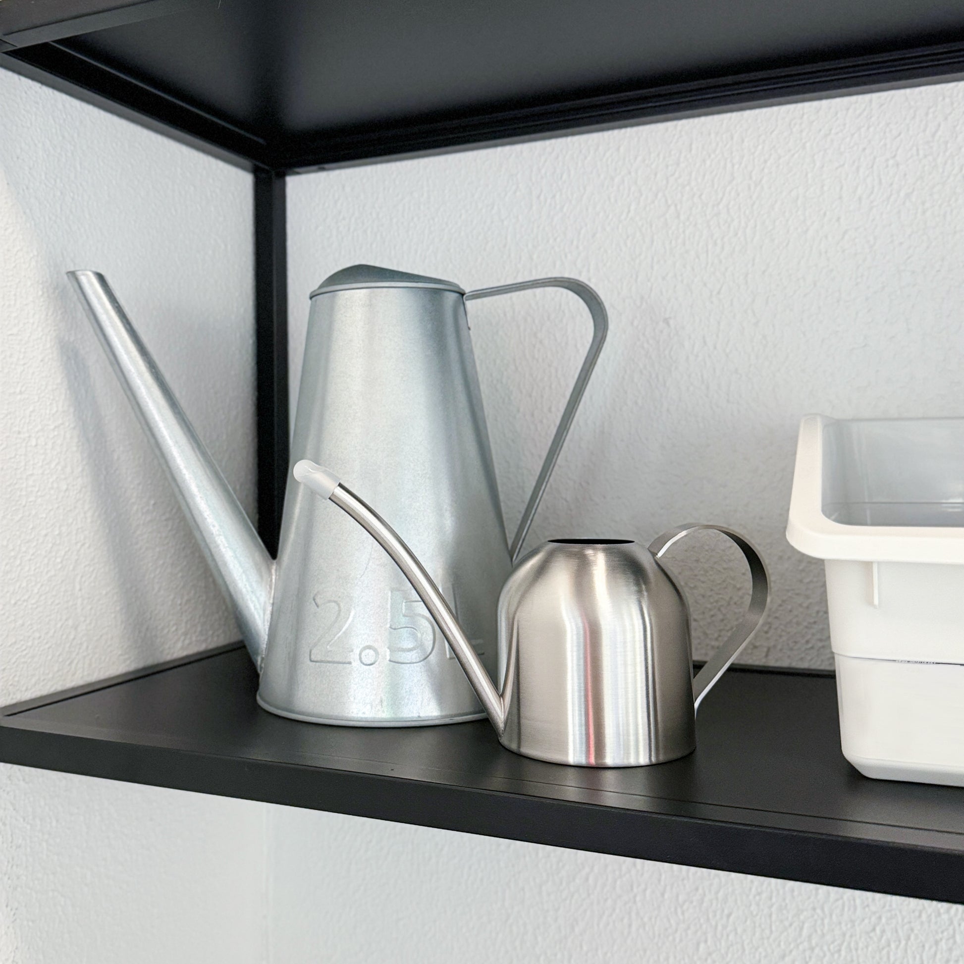 Mini Stainless Steel Plant Watering Can displayed beside a 2.5L watering can showing the compact size difference