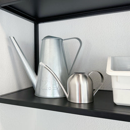 Mini Stainless Steel Plant Watering Can displayed beside a 2.5L watering can showing the compact size difference