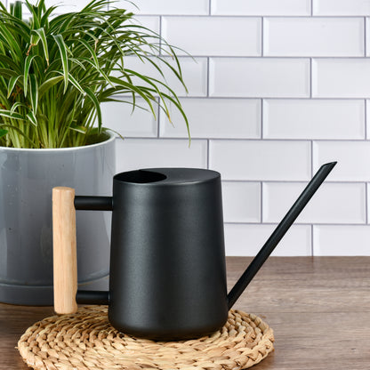 Stainless Steel Watering Can with Wooden Handle placed on table mat