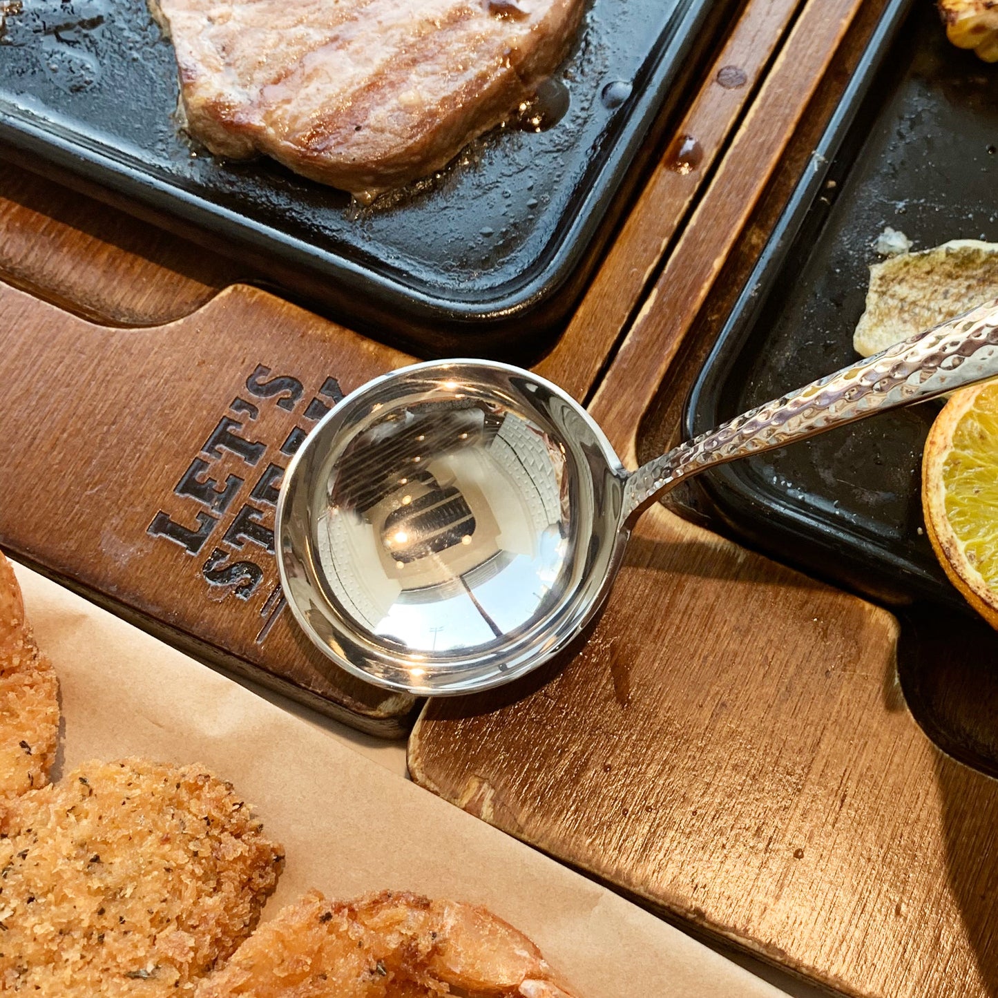 IMEEA stainless steel sauce ladle with polished reflective surface