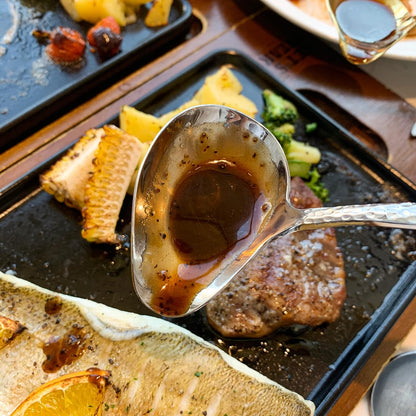 IMEEA stainless steel gravy ladle close-up with black pepper sauce