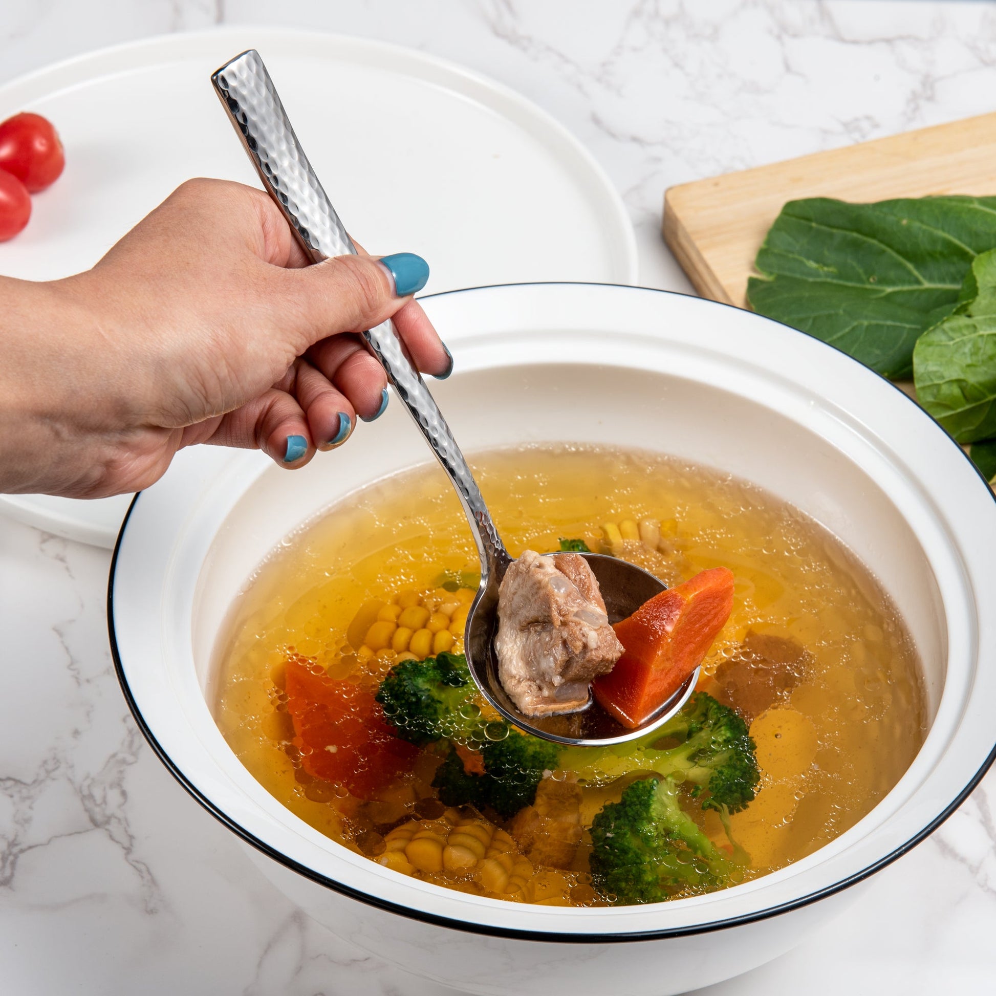 IMEEA 18/10 stainless steel sauce ladle scooping food from soup