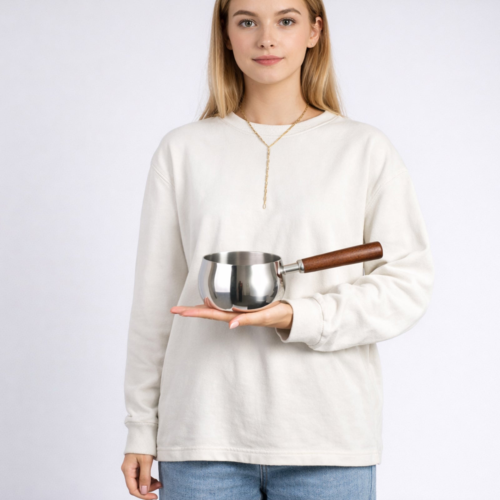 Milk pot placed on the palm, highlighting its compact size and design